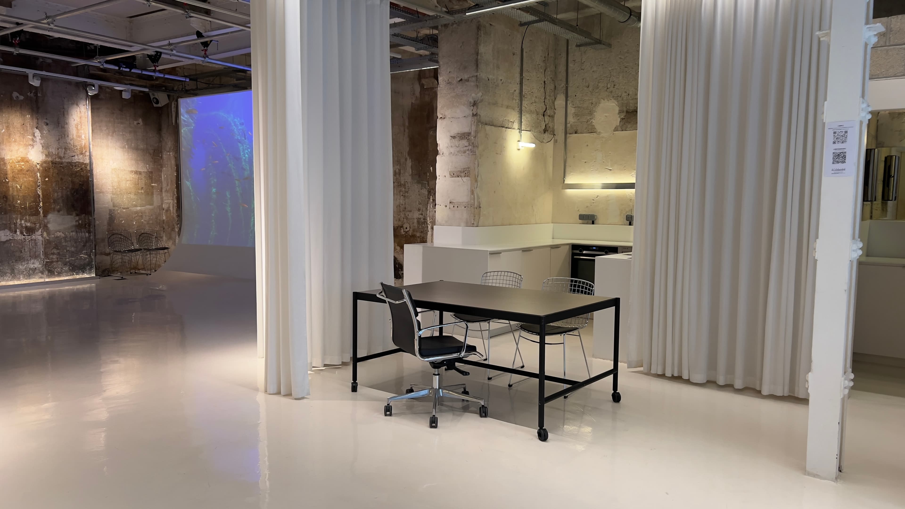 Interior of Chez Les Plombiers — 200 m² brutalist event space with stone walls and metal beams, Paris 1st