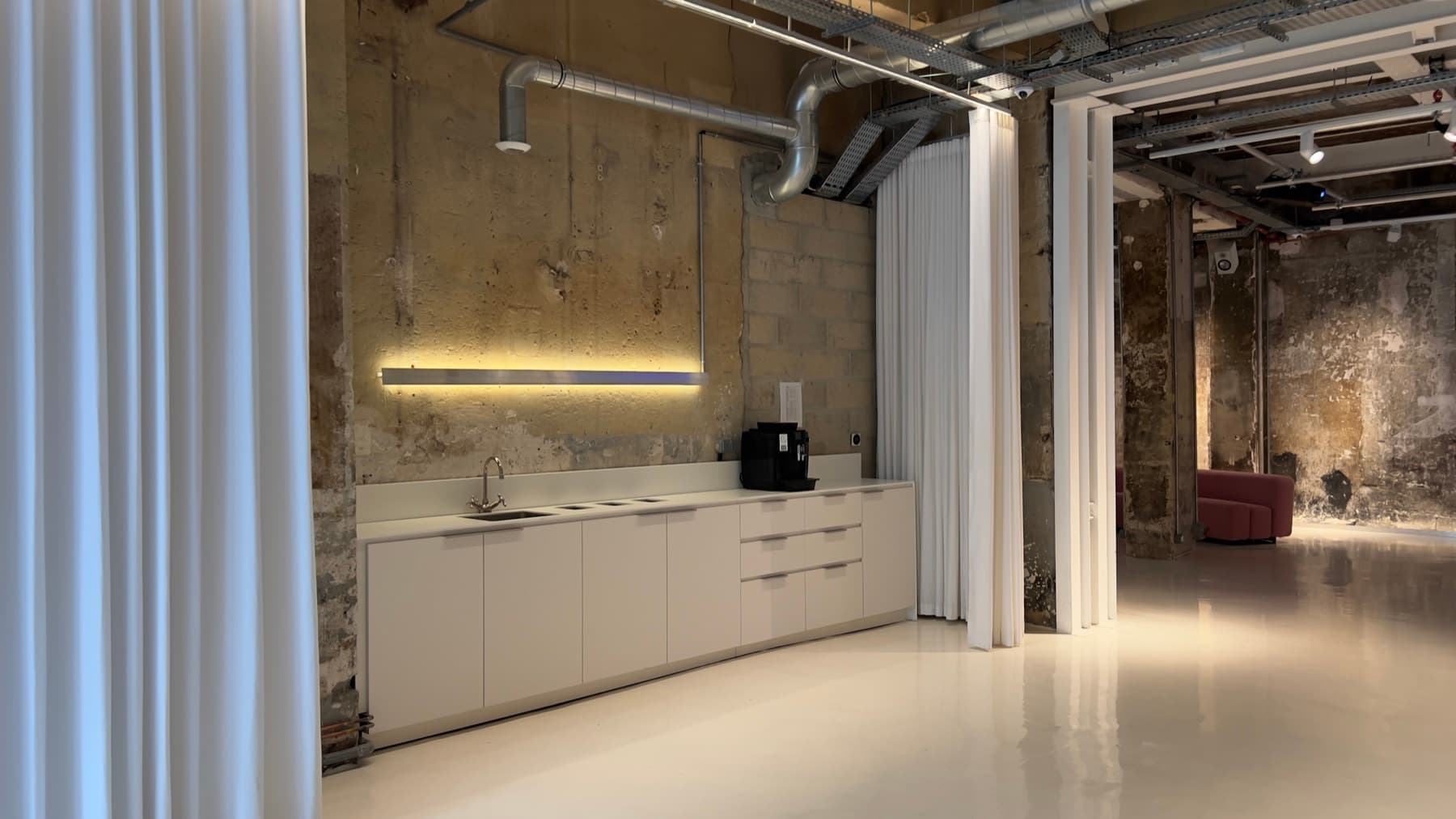 Large-format projection screen in the main hall — Chez Les Plombiers, Paris 1st