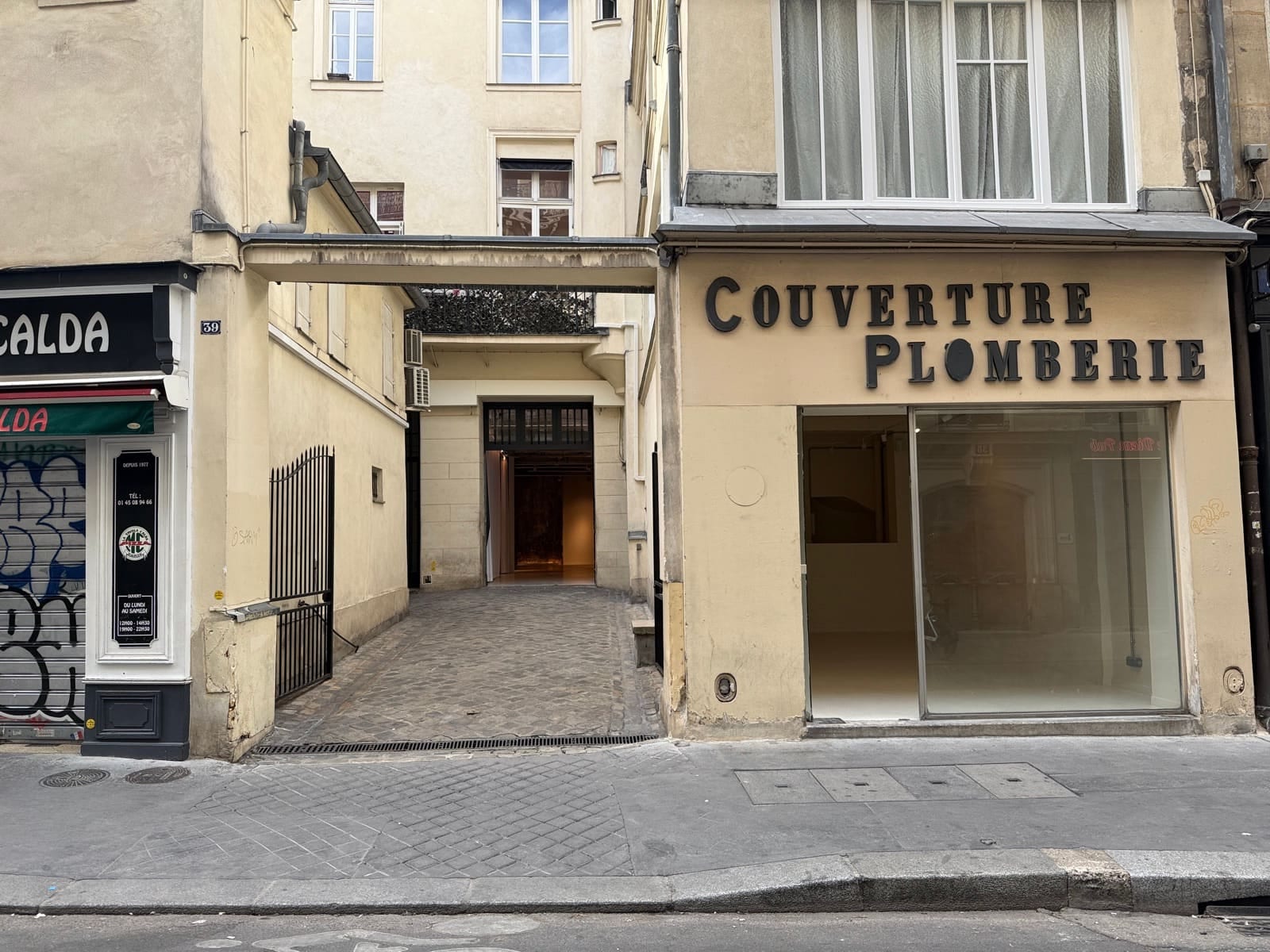Le 39 rue des Bourdonnais : la grille ouverte sur la cour, et la vitrine de La Boutique